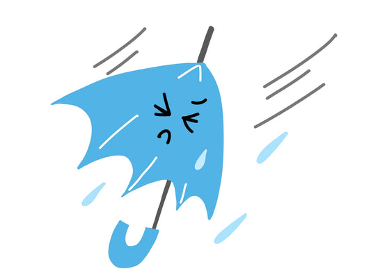 雨の日に傘を持ち体のだるさを感じている女性の写真